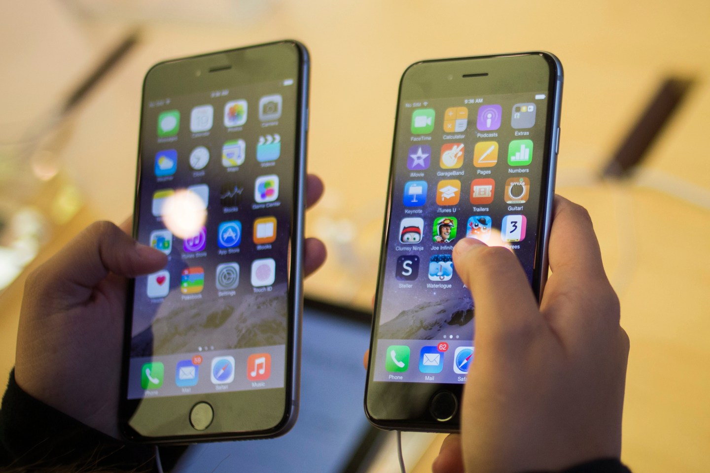A customer holds an iPhone 6 and iPhone 6 Plus after the phones went on sale at the Fifth Avenue Apple store in Manhattan, New York