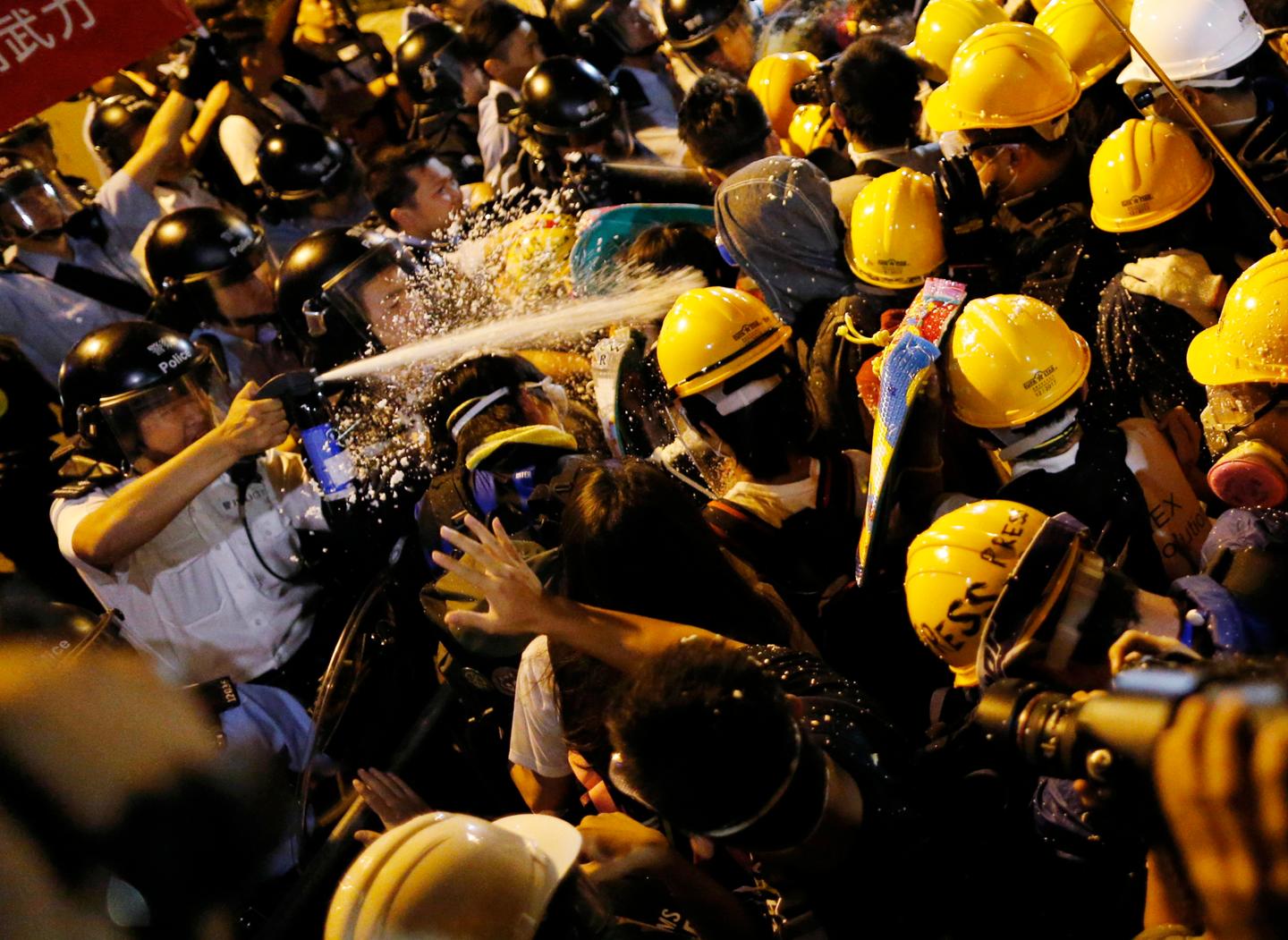 Police use pepper spray during clashes with pro-democracy protesters close to the chief executive office in Hong Kong