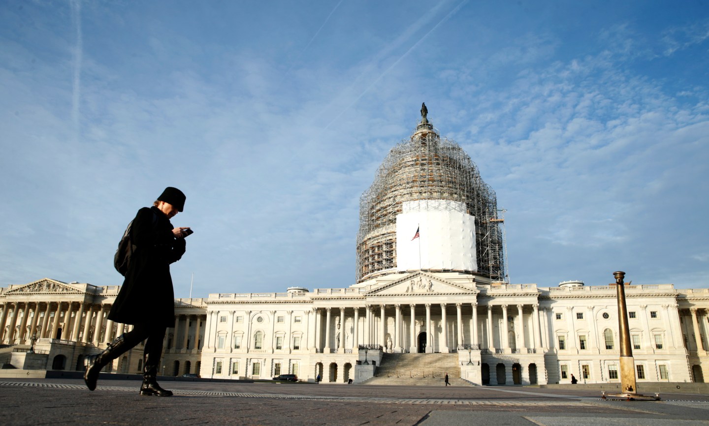 A woman walks past the U.S. Capitol in Washington