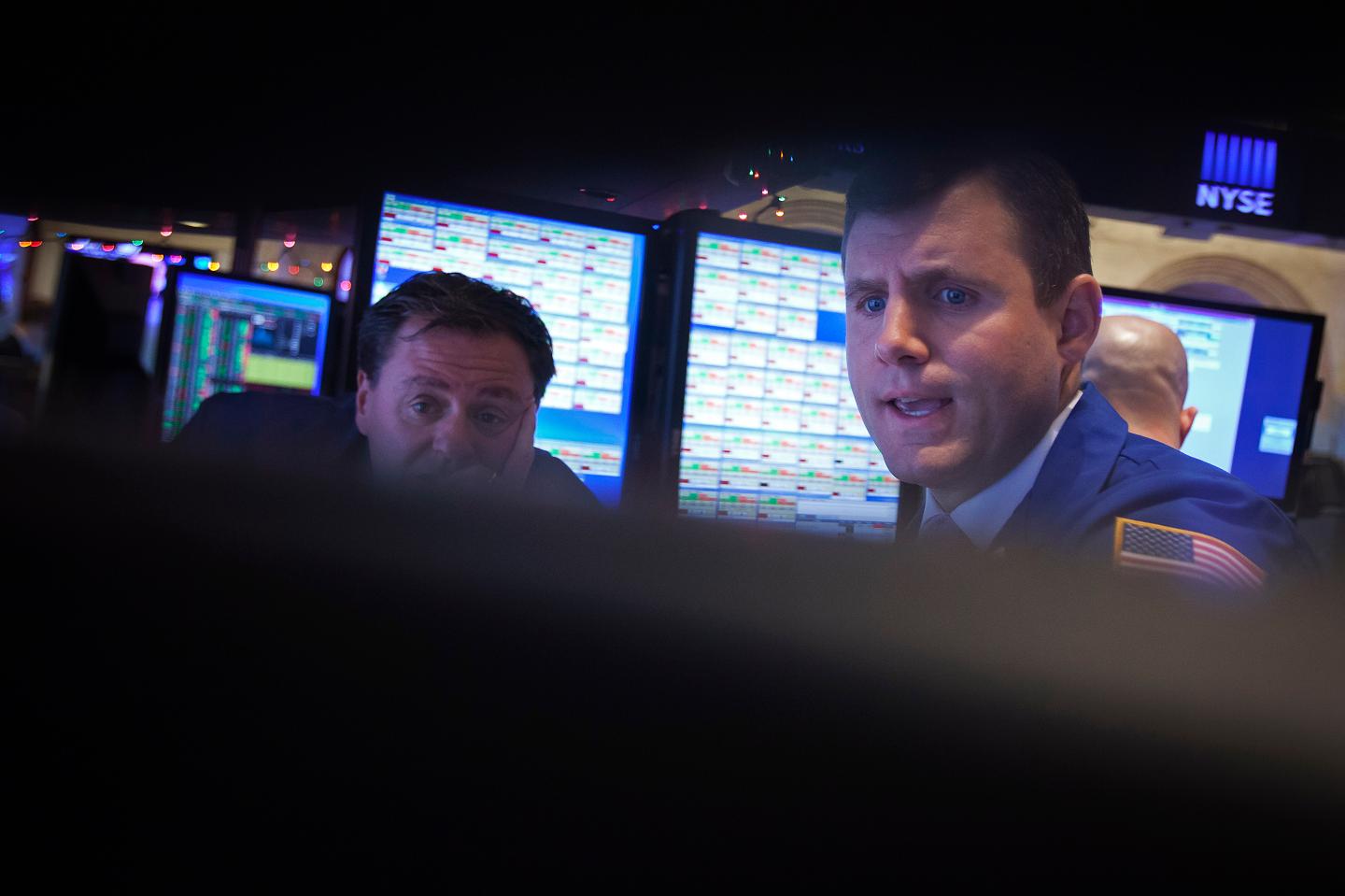 Traders work on the floor of the NYSE in New York