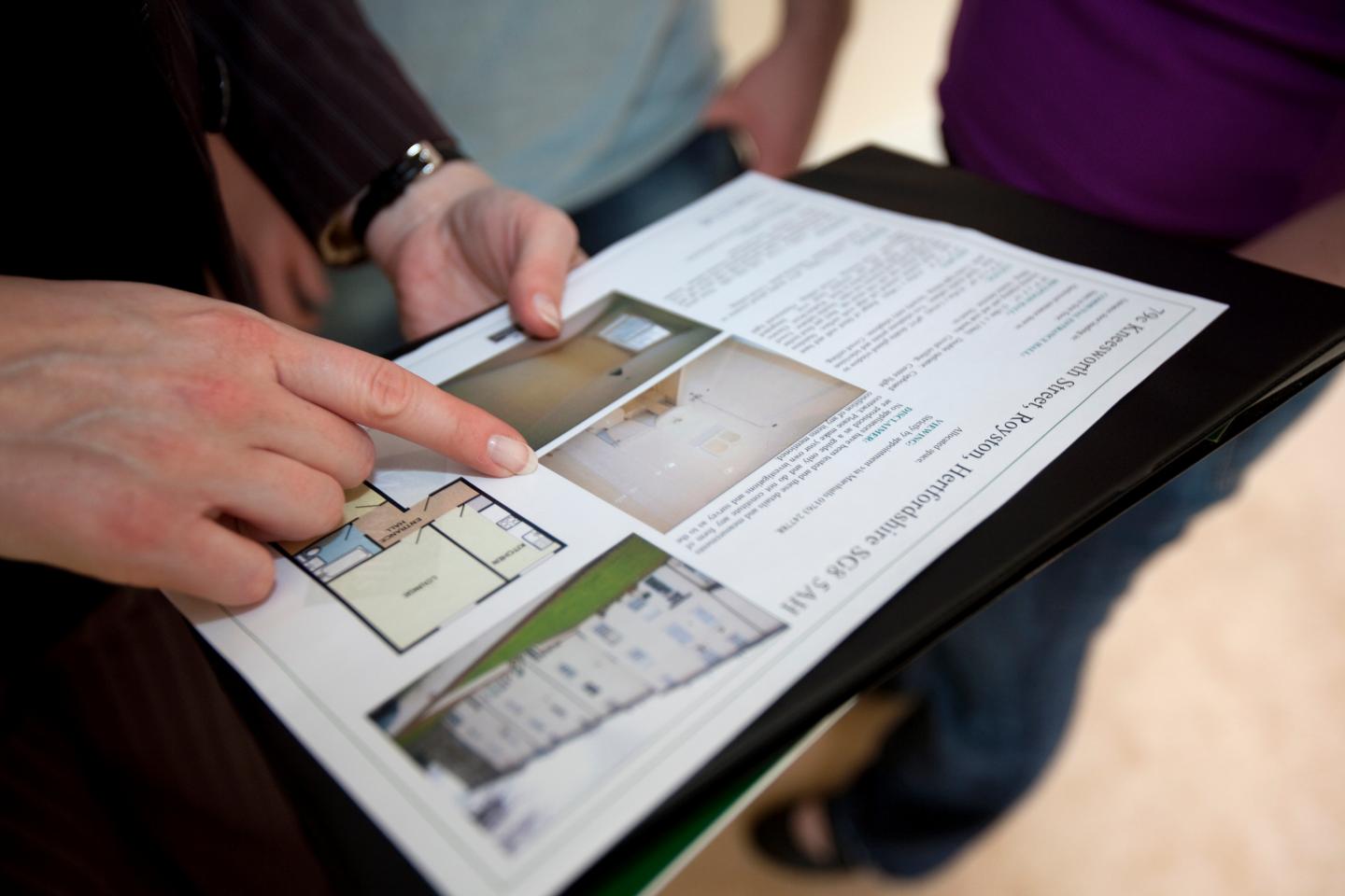 A young couple hoping to enter the property market are shown around a house by an Estate Agent