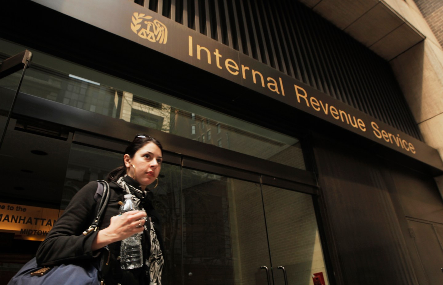 A woman walks out of an Internal Revenue Service office in New York
