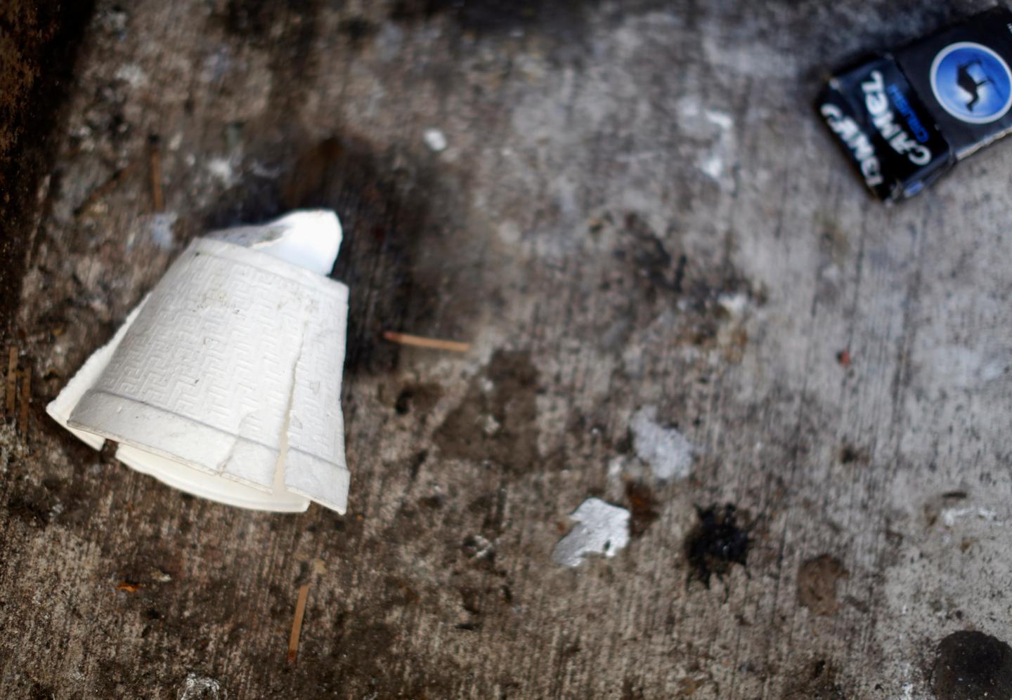A crushed Styrofoam coffee cup lays on the ground in New York