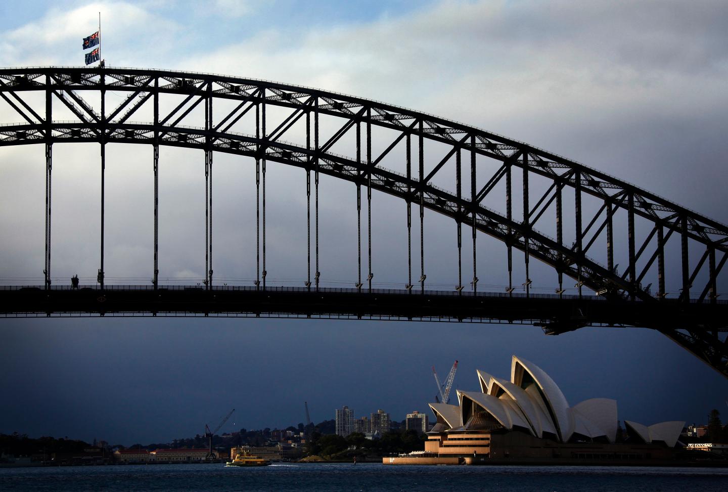 Australian flags fly at half-mast atop the Sydney Harbour Bridge as a sign of respect for those killed in the Malaysia Airlines MH17 crash