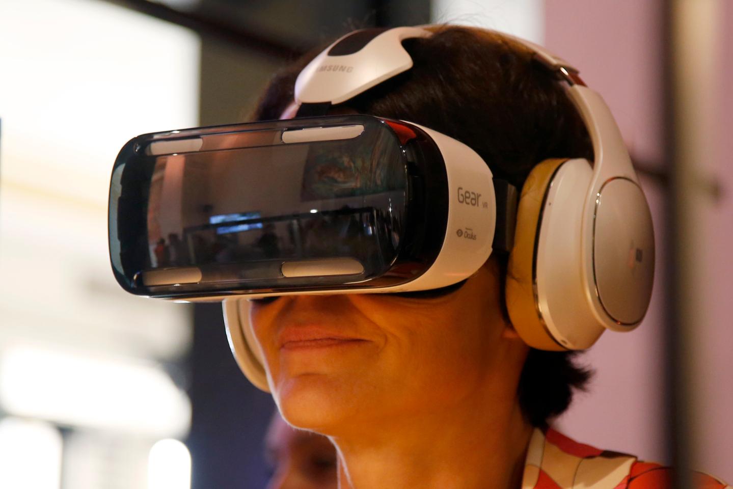 An attendee tries an Oculus-powered Samsung Gear VR headset during the French telecom Orange annual company's innovations show in Paris