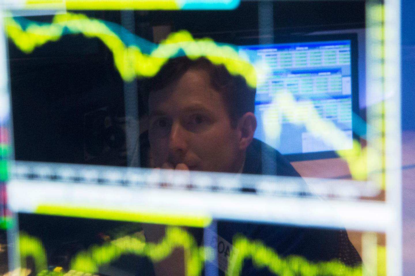 Trader watches the screen at his terminal on the floor of the New York Stock Exchange in New York