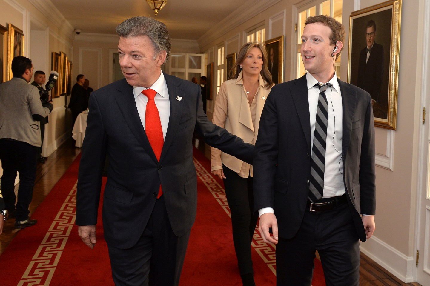 President, founder and CEO of Facebook Mark Zuckerberg and Colombia's President Juan Manuel Santos walk before an event at the presidential palace in Bogota