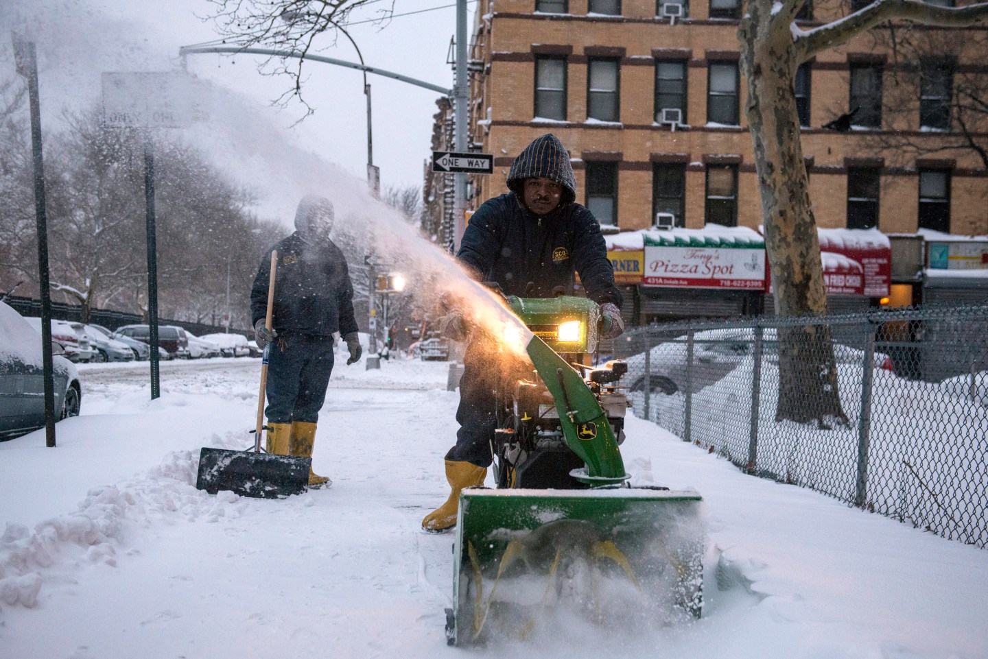 A man plows a sidewalk after a snow storm in the Brooklyn borough of New York