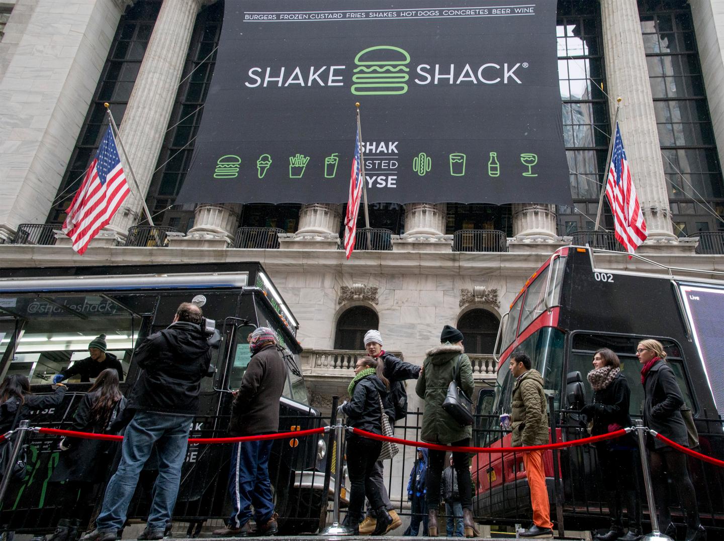 Patrons stand in line for free breakfast from Shake Shack in front of New York Stock Exchange to celebrate the company's IPO