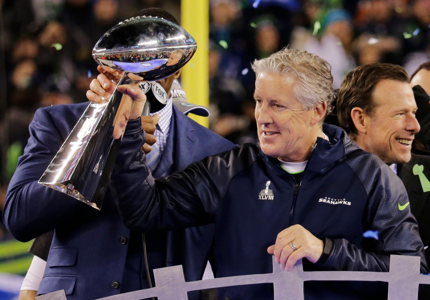 Seahawks head coach Carroll holds the Vince Lombardi trophy to after the Seahawks defeated the Broncos in the NFL Super Bowl XLVIII football game in East Rutherford