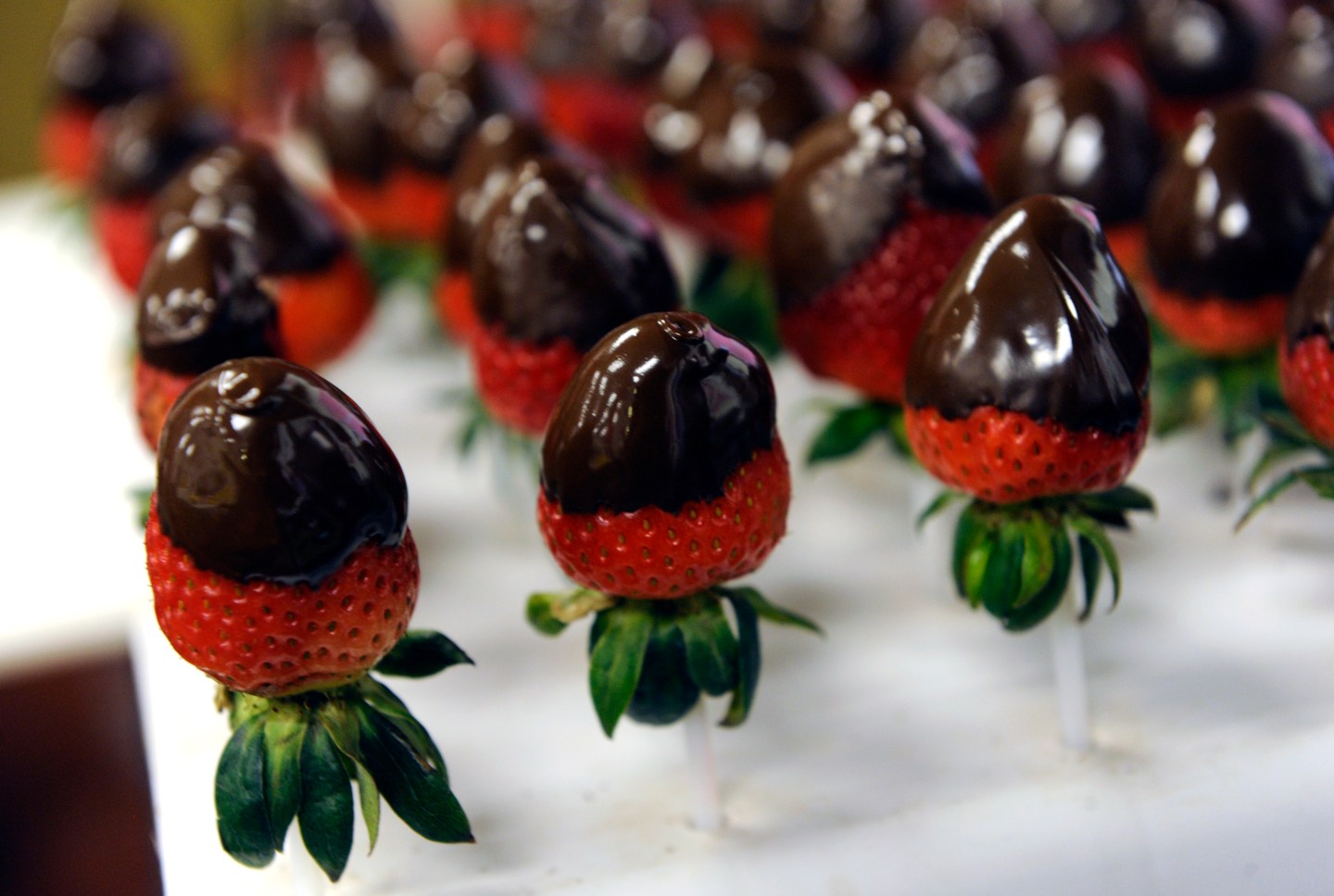Hand dipped chocolate covered strawberries are prepared for the arrangements. All of the edible arrangements are completely hand made from the cutting of the fruit in designs such as hearts or daisies to dipping strawberries, bananas and apples into eithe