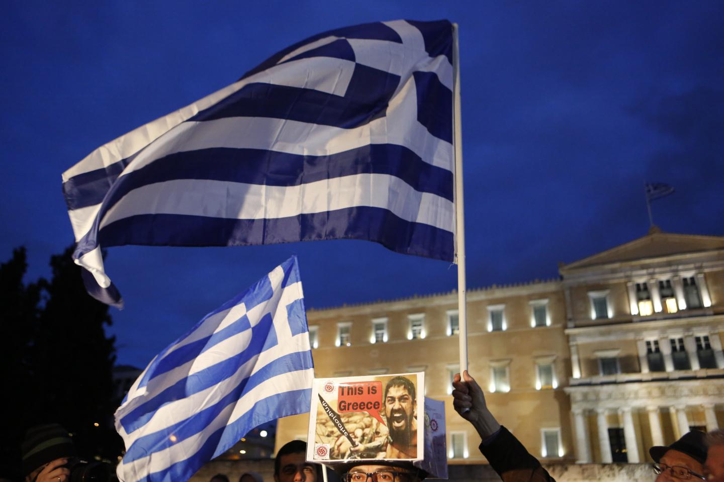 captionA large Greek flag flies outside the Greek Parliament