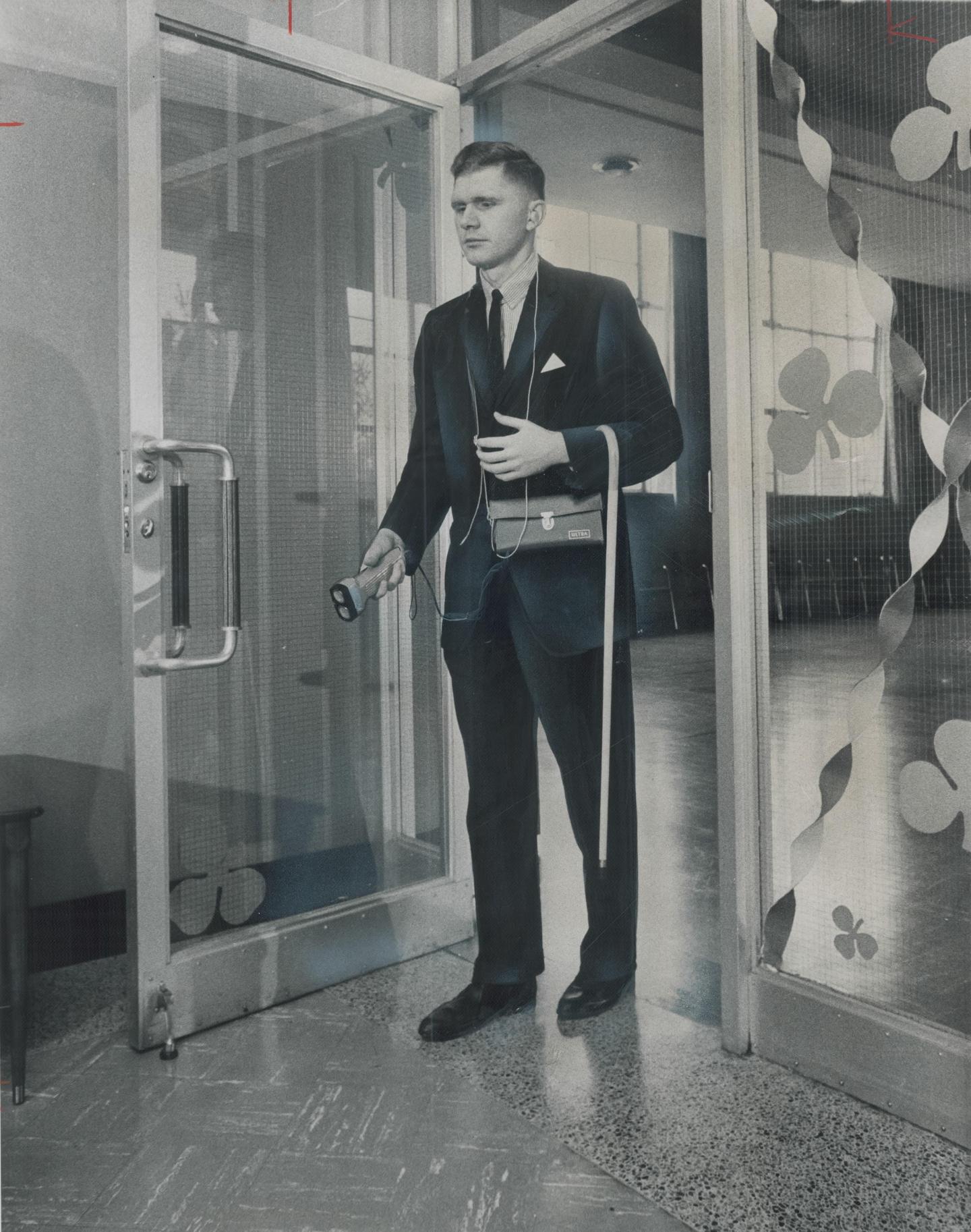 Electronic 'White Cane'; White cane hangs loosely over the arm of Graham Stoodley as he tries out ne