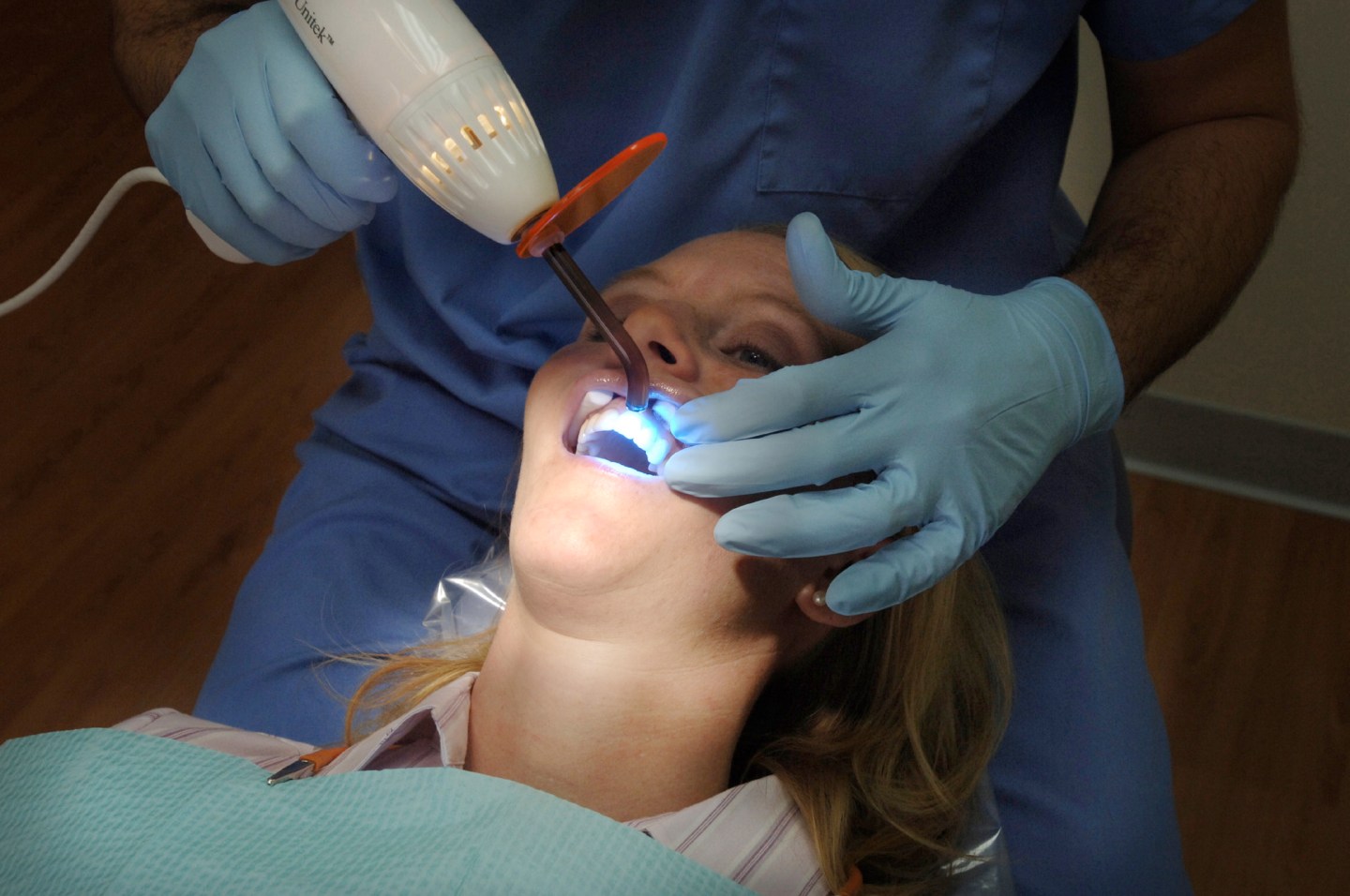 Dr. Alex Mazurenko uses a high intensity light to activate the carbamide peroxide whitening solution