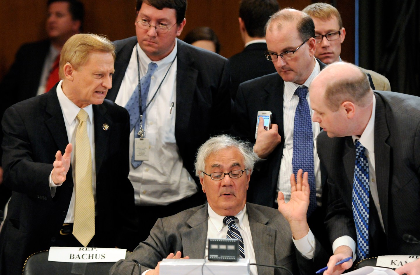 Frank talks with a group including Bachus during a recess from a committee conference on Wall Street reform on Capitol Hill