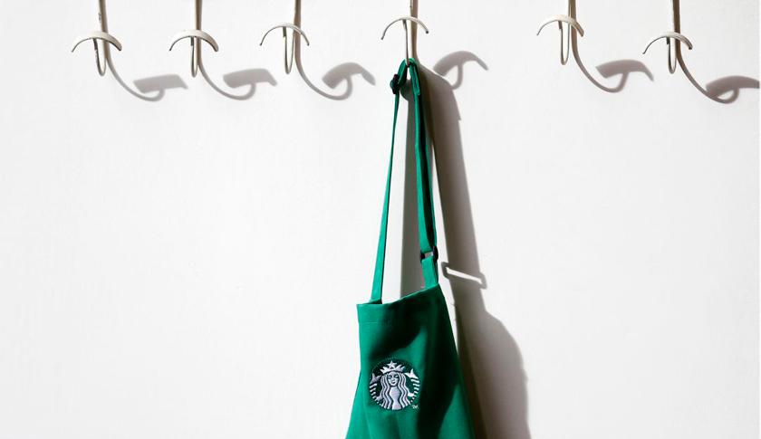 A barrista's apron hangs on a peg in Starbucks' Mayfair Vigo Street branch in central London