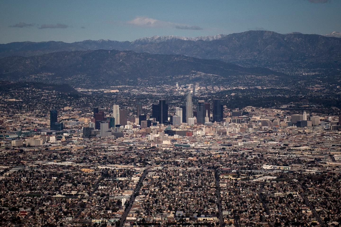 The Los Angeles skyline and the San Gabriel Mountains are seen in this aerial photo