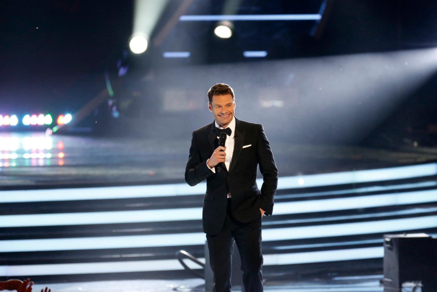 Host Ryan Seacrest speaks on stage during the American Idol XIII 2014 Finale in Los Angeles