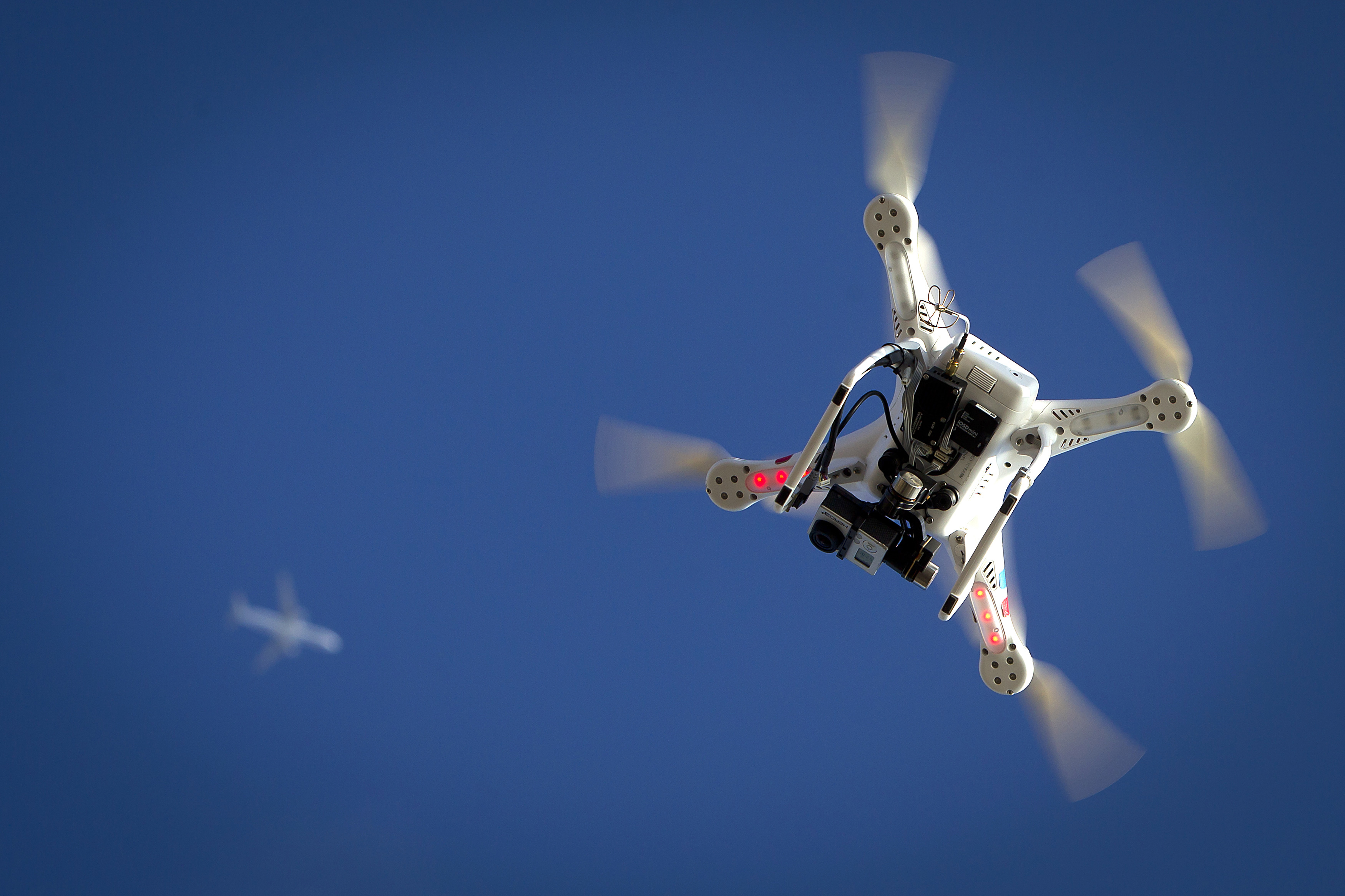 Airplane flies over a drone during the Polar Bear Plunge on Coney Island in the Brooklyn borough of New York