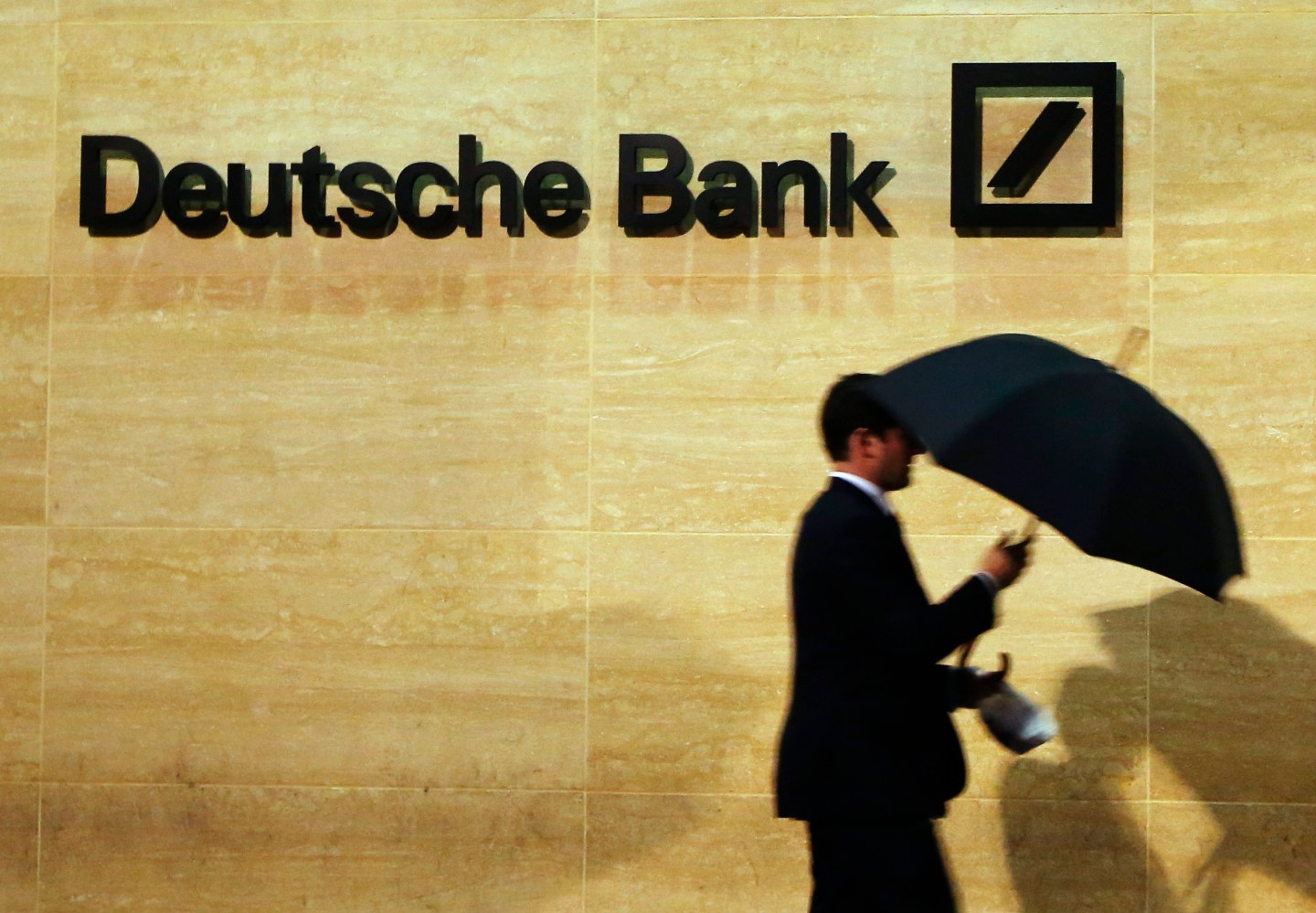 A man walks past Deutsche Bank offices in London