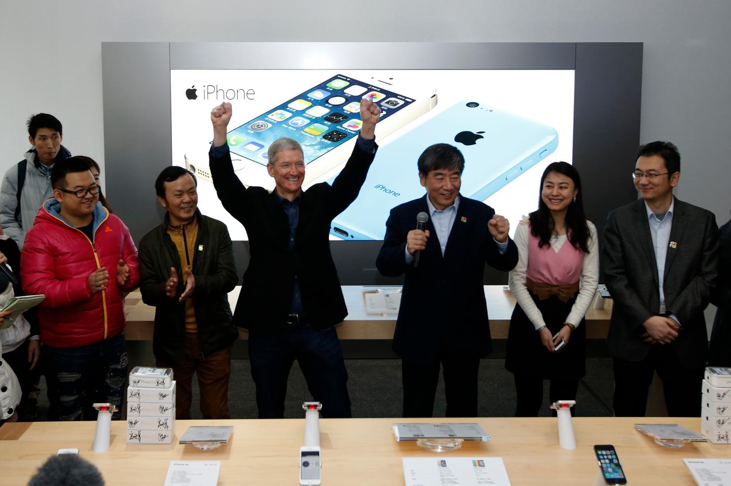 Apple Inc. CEO Tim Cook reacts at an event celebrating the launching of Apple's iPhone on China Mobile's network in Beijing
