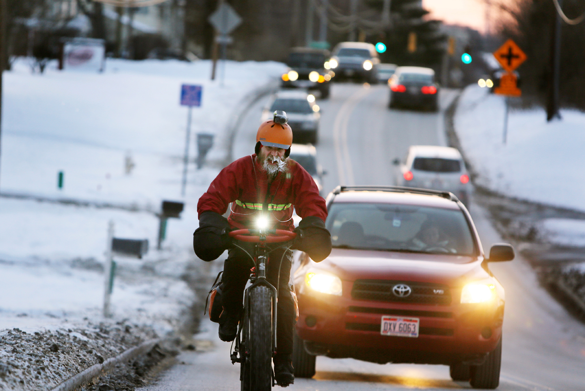 SUB ZERO BIKE COMMUTER Wed., February 19, 2014 Fraser Cunningham, 56, of Madeira, a GE Engineer, bicycles home to work Thursday evening in single digit temperatures. Cunningham hasn't missed a day biking to and from work for a year and a half. The Enquirer/Carrie Cochran