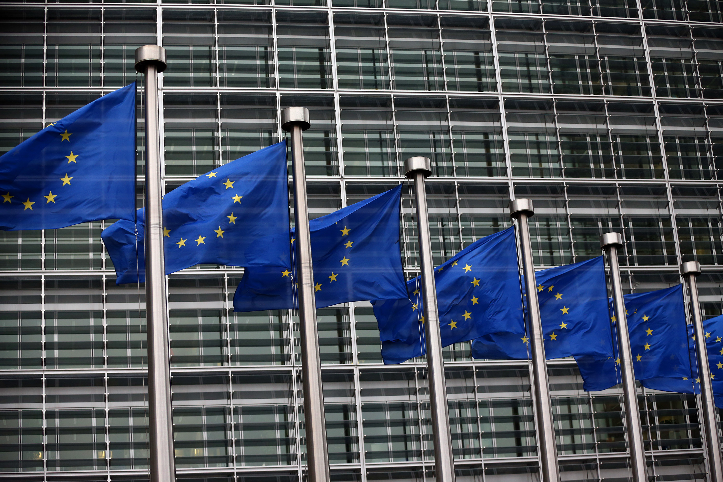 Caption:BRUSSELS, BELGIUM - OCTOBER 24: European Union flags are pictured outside the European Commission building on October 24, 2014 in Brussels, Belgium. Alongside criticism from outgoing European Commission president Jose Manuel Barroso on the UK's stance on EU immigration and a plan to quit the European Court of Human Rights, the UK has now been told to pay an extra £1.7bn GBP (2.1bn EUR) towards the EU's budget because its economy has performed better than expected. (Photo by Carl Court/Getty Images)

