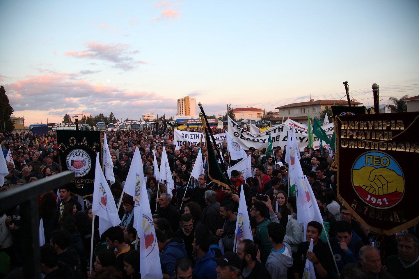 Protesters holding banners and plakat against ECB members