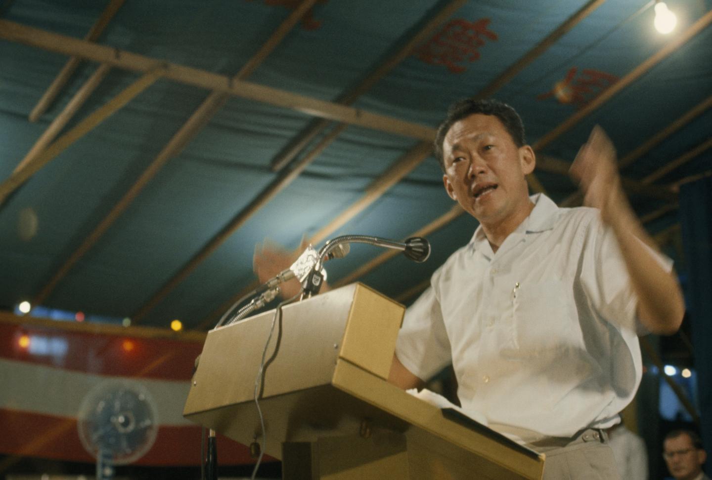 Prime minister stands at a podium and dedicates a housing project