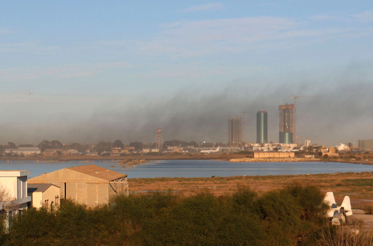 Smoke rises after an airstrike hit Maitiga airport early Thursday morning, in Tripoli