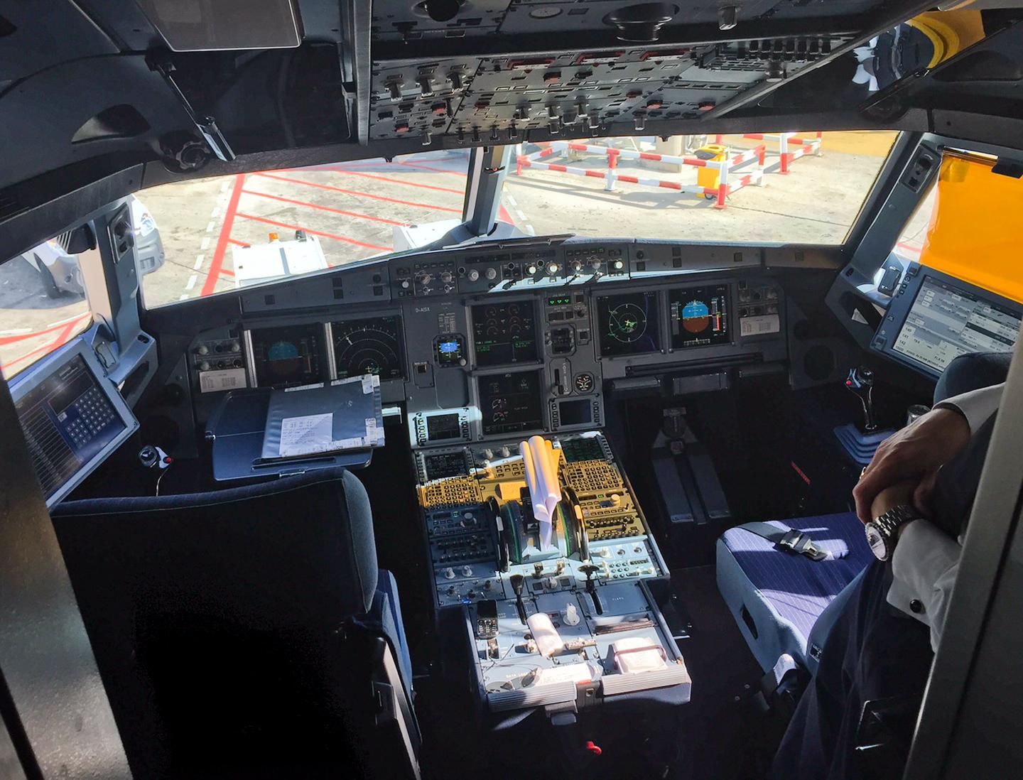 A pilot stands inside the cockpit of Airbus A321 during boarding in Barcelona