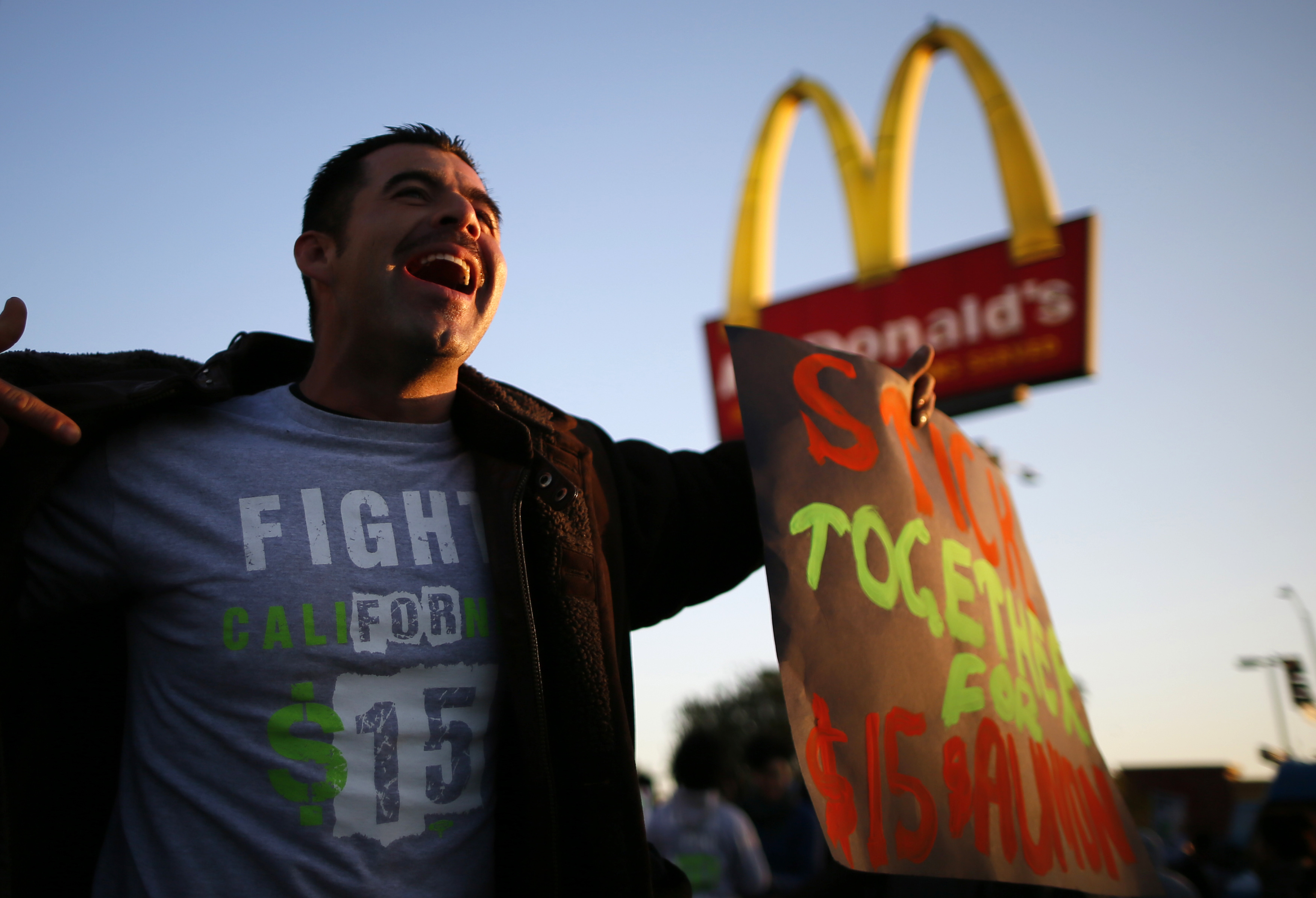 Striking McDonald's worker Abran Escarzaga, 31, protests outside McDonald's in Los Angeles