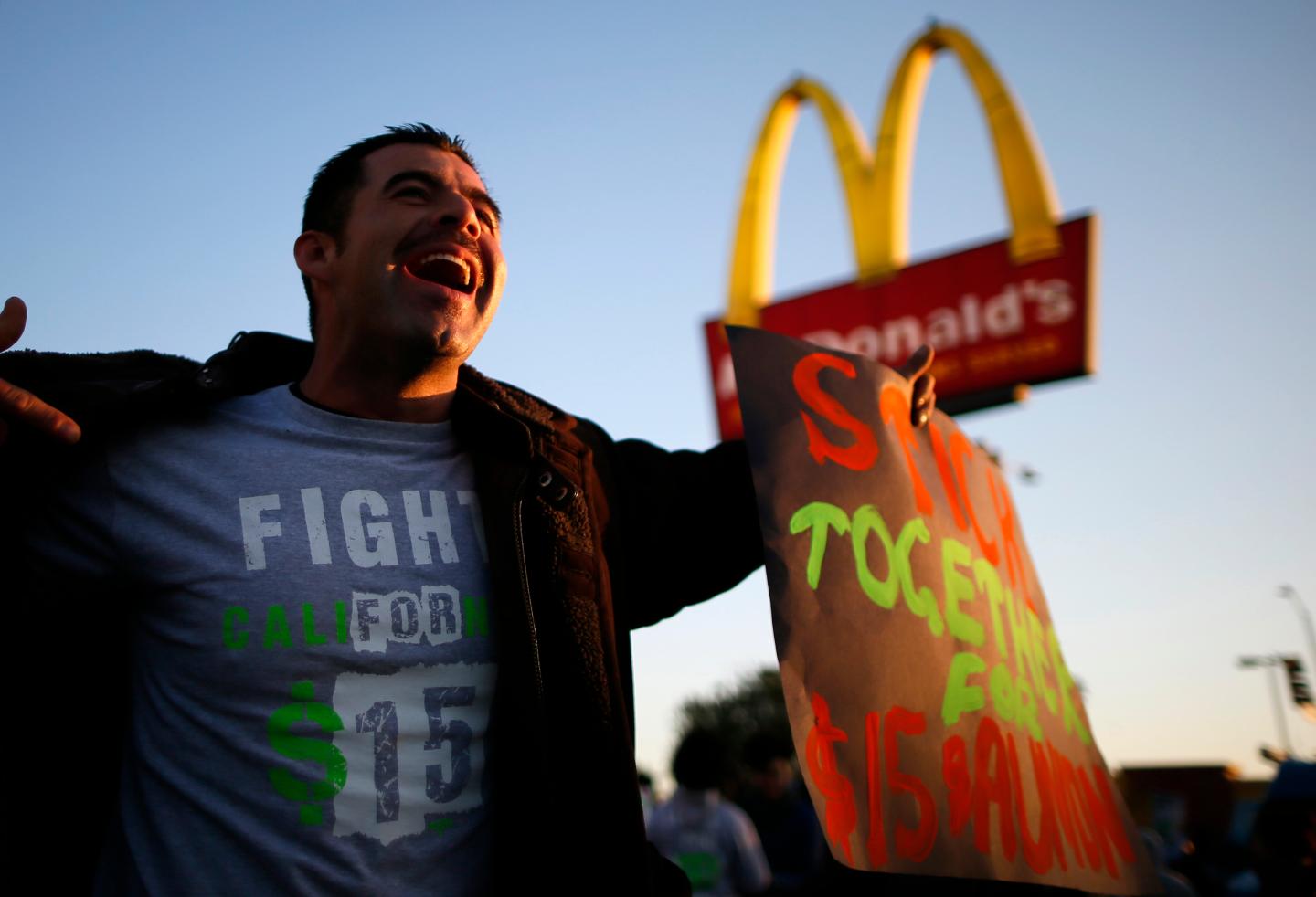 Striking McDonald's worker Abran Escarzaga, 31, protests outside McDonald's in Los Angeles