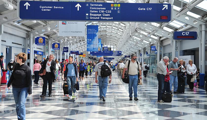 Travellers walk down a concourse at Chic
