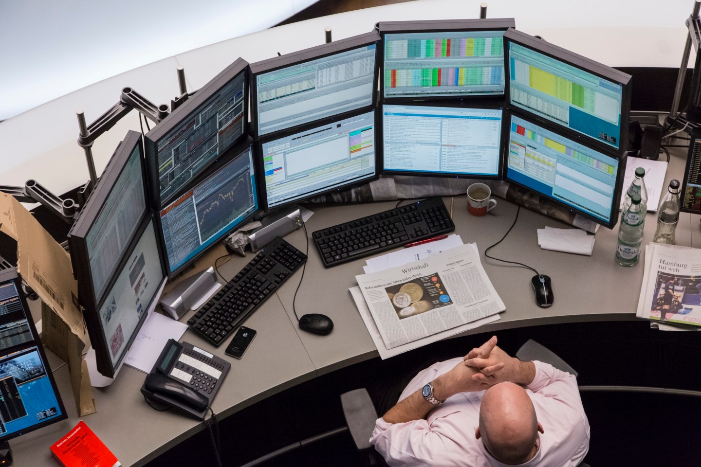 A financial trader monitors data on computer screens at the Frankfurt Stock Exchange in Frankfurt, Germany, on Monday, March 9, 2015. With the European Central Bank buying its first government bonds this week to shore up the region's economy, options traders are showing little concern that the DAX Index might decline. Photographer: Martin Leissl/Bloomberg