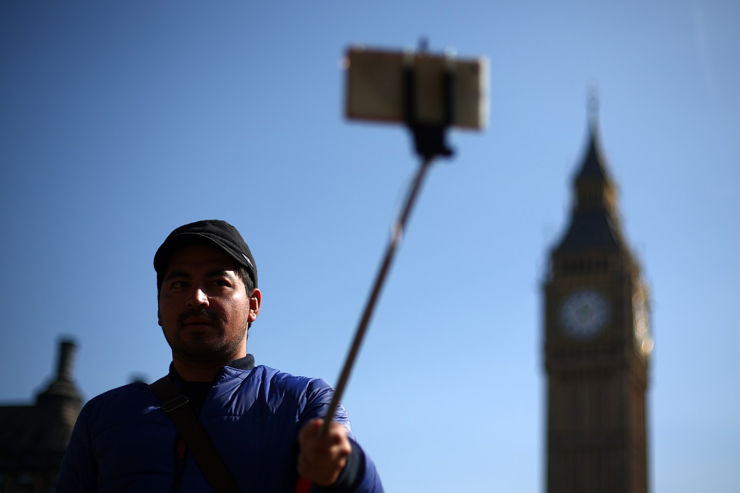 LONDON, ENGLAND - APRIL 07: A tourist takes a selfie photograph in front of Big Ben using a selfie stick in on April 7, 2015 in London, England. Parts of Britain basked in sunshine today as temperatures in London reached 16 degrees celsius. (Photo by Carl Court/Getty Images)