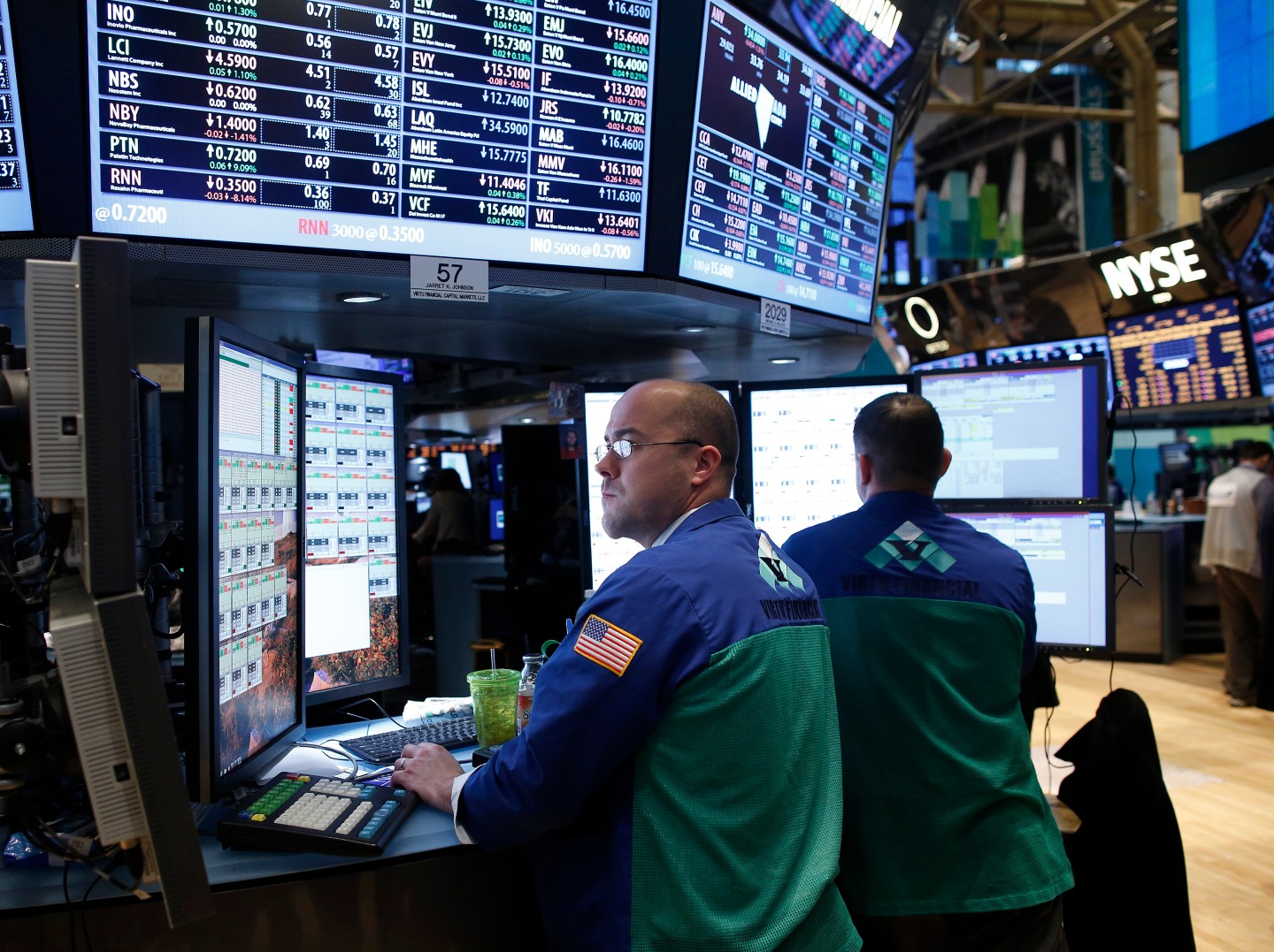 Trader Jarret Johnson of Virtu Finalcial looks at multiple computer monitors while working at a newly renovated section of trading stations on the floor of the New York Stock Exchange