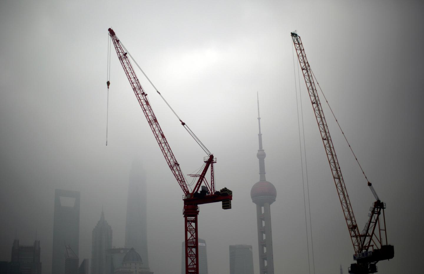 Construction cranes are see near Pudong financial district of Shanghai