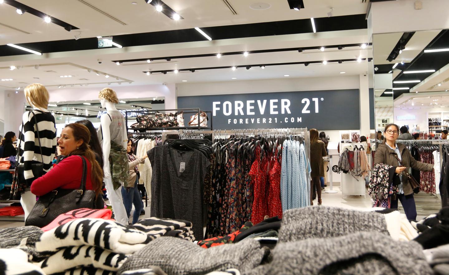 Customers browse through clothes at the first Forever 21 retail store in Lima, at Real Plaza Salaverry shopping mall