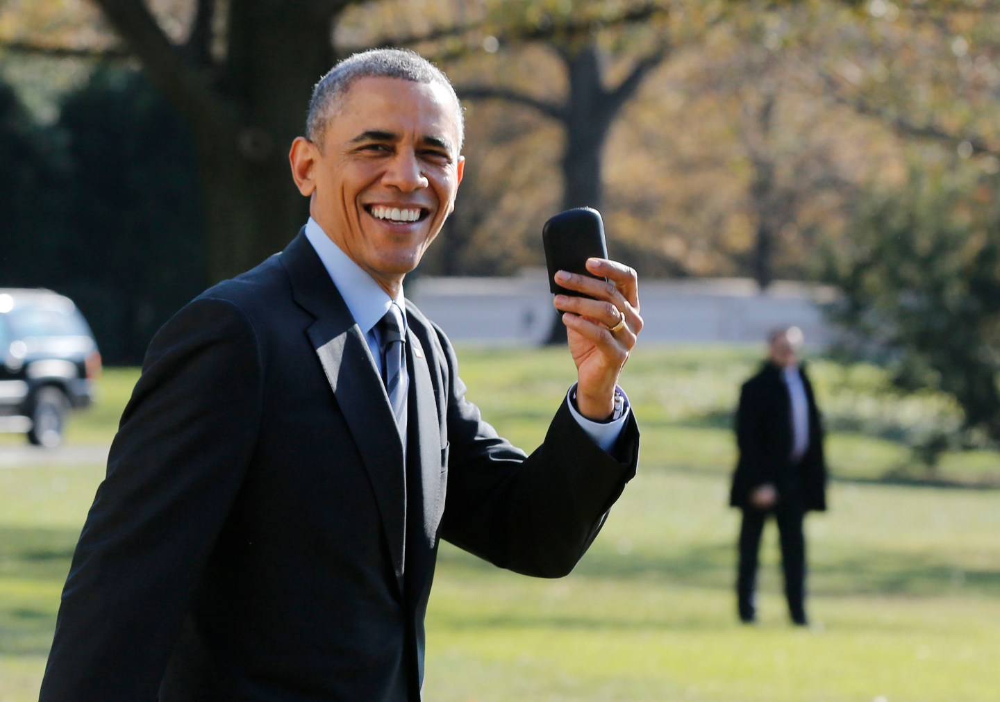 U.S. President Obama holds up his BlackBerry device after he returned inside the White House to retrieve it, after boarding Marine One on the South Lawn of the White House in Washington