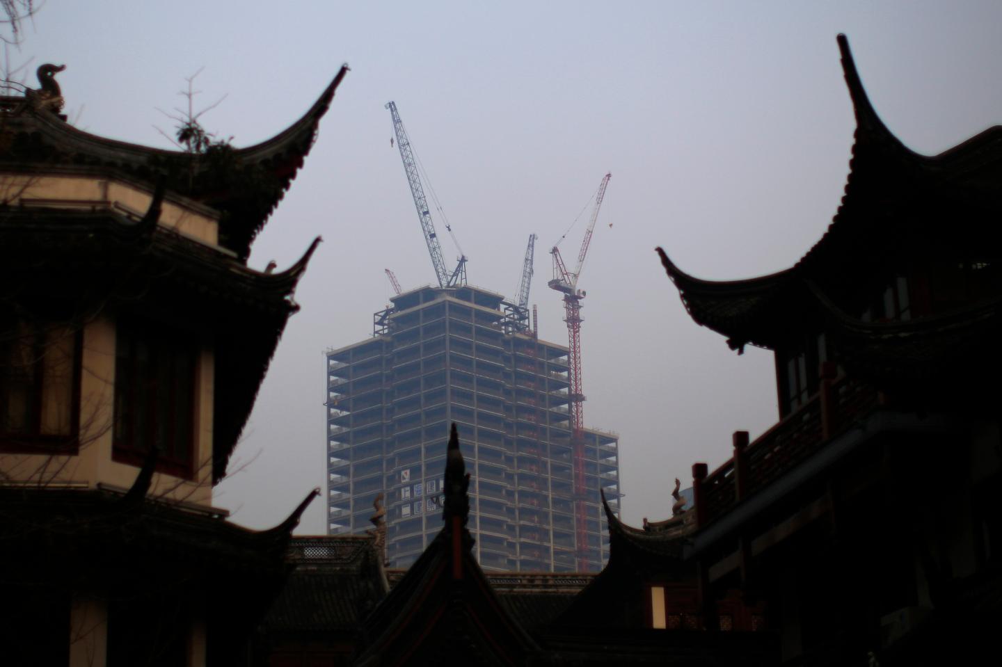 A building under construction is seen near the traditional Yu Yuan Garden in downtown Shanghai