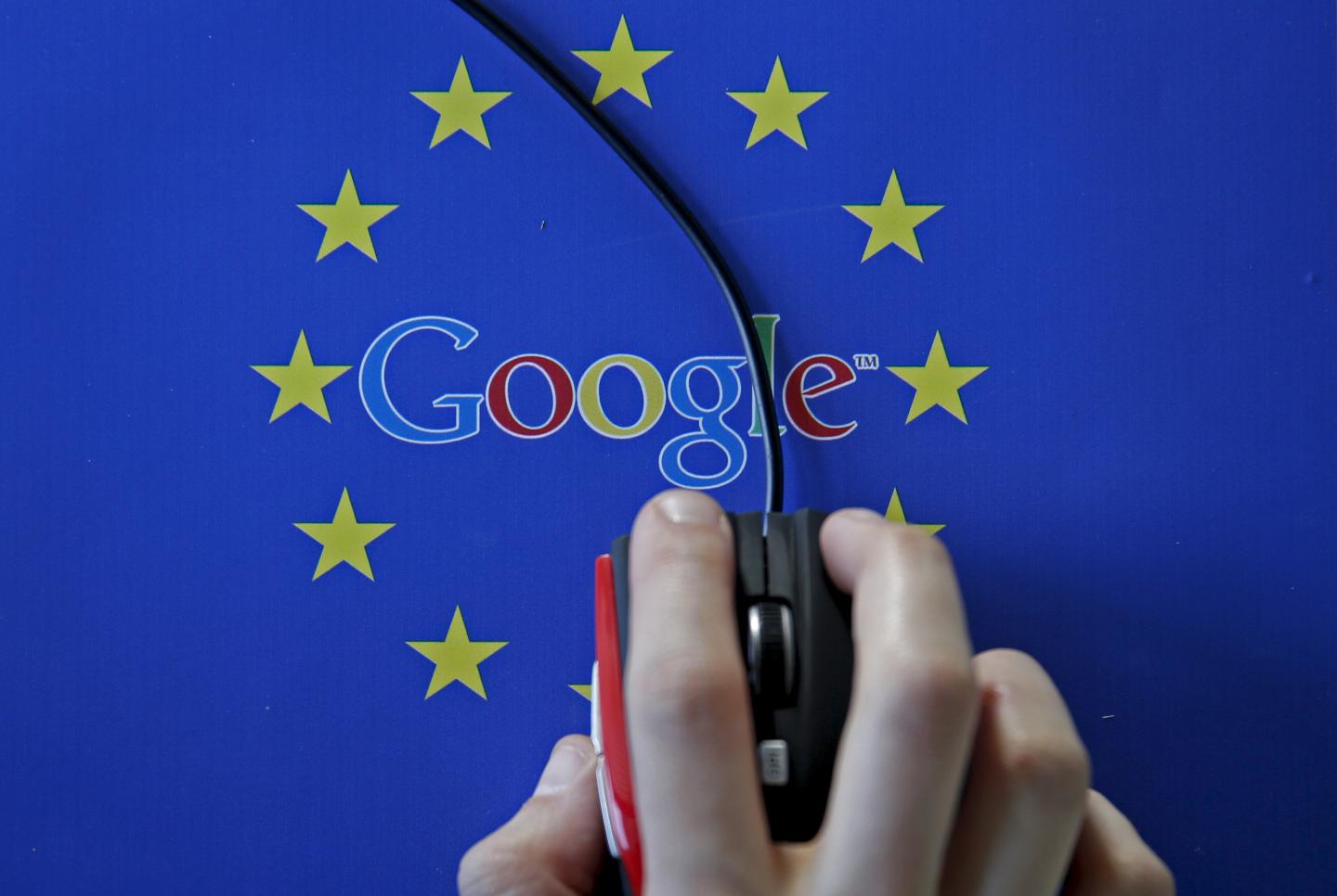 A woman hovers a mouse over the Google and European Union logos in Sarajevo