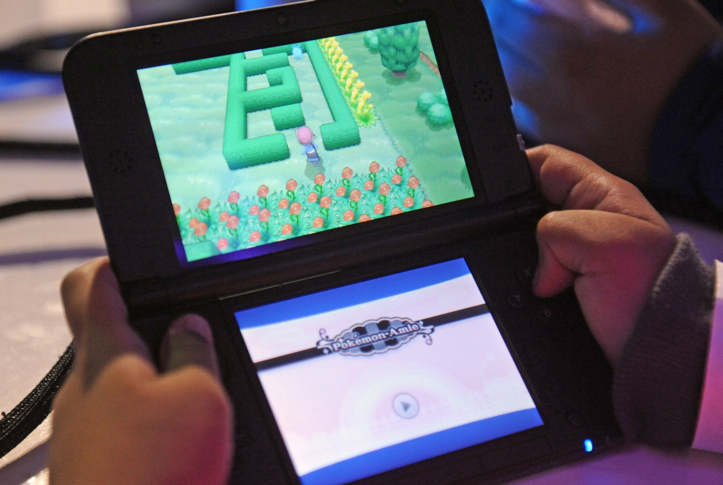 Attendees play a demo version of Pokemon X and Pokemon Y on the Nintendo 3DS at one of several kiosks in New York on Friday, Oct. 11, 2013.The event celebrates the release of the two new games. Photographer: Louis Lanzano/ Bloomberg *** Local Caption *** Nintendo