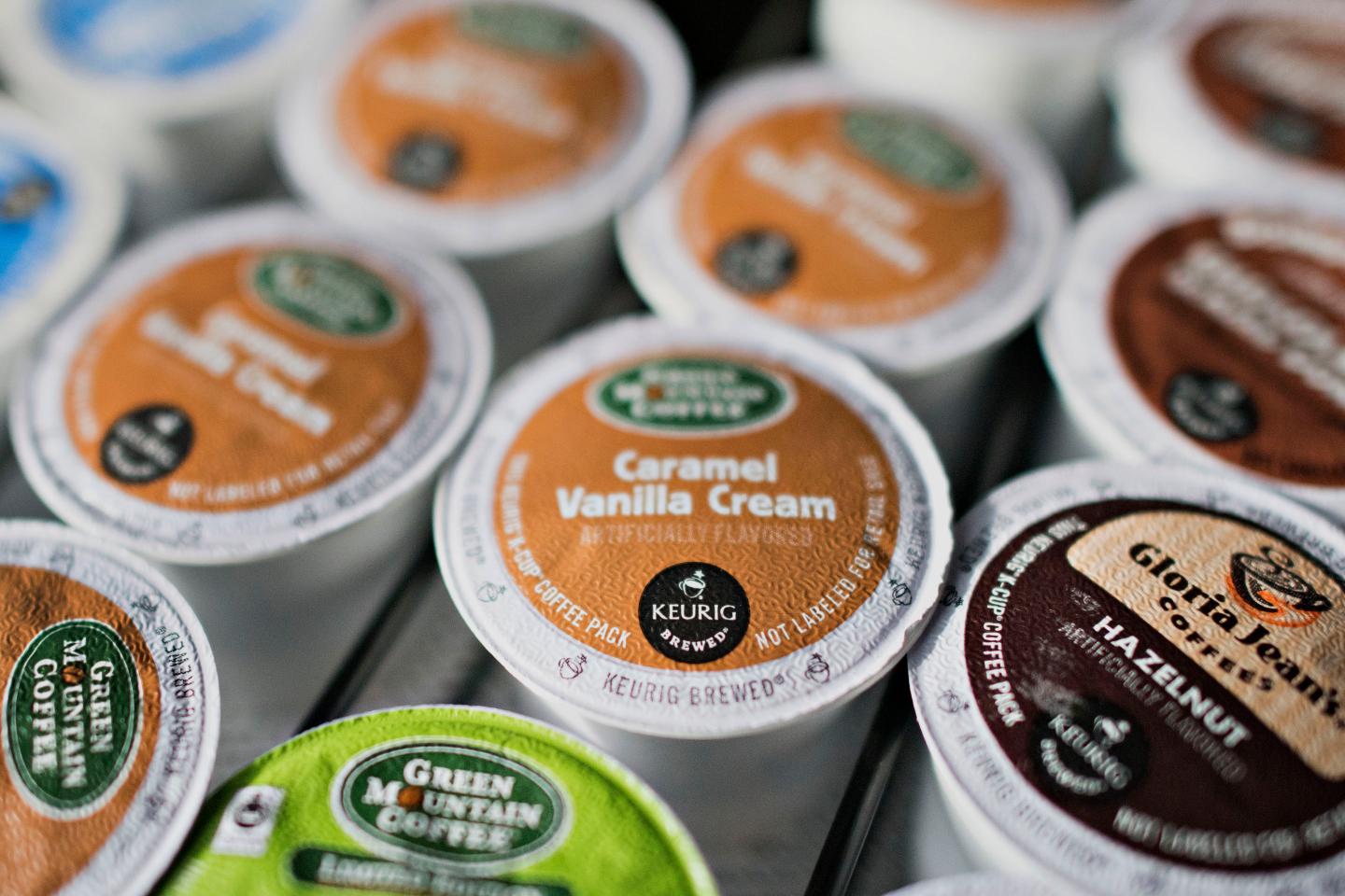 Keurig Green Mountain Inc. "K-cup" coffee pods sit near a coffee machine in a salon in Princeton, Illinois, U.S., on Tuesday, Feb. 3, 2015. Keurig Green Mountain Inc., is scheduled to report quarterly earnings on Feb. 4. Photographer:  Daniel Acker/Bloomberg