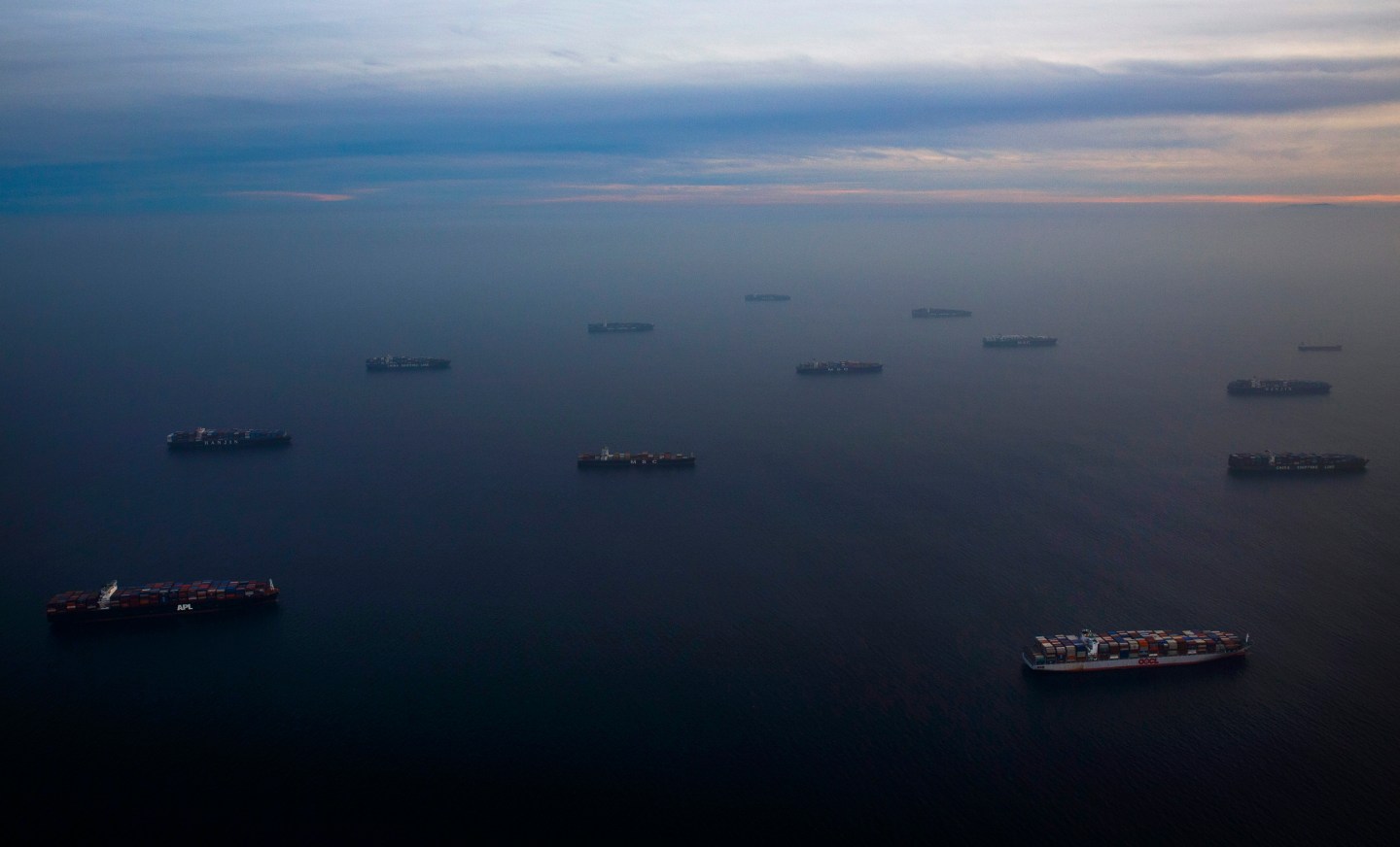 Ships waiting to unload cargo are seen waiting in the Pacific Ocean in this aerial photograph taken above the Port Of Los Angeles in Los Angeles, California, U.S., on Wednesday, Feb. 18, 2015. United Steelworkers members who help run crude terminals at a California port are threatening to join a national oil workers’ strike at U.S. refineries. Photographer: Patrick T. Fallon/Bloomberg