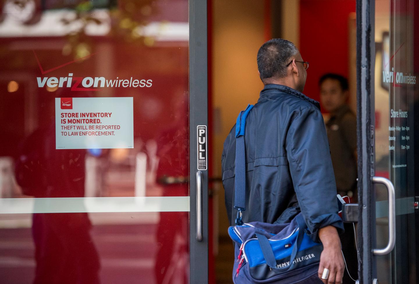 A pedestrian enters a Verizon Communications Inc. store in San Francisco, California, U.S., on Wednesday, April 15, 2015. Verizon Communications Inc. is scheduled to release earnings data on April 21. Photographer: David Paul Morris/Bloomberg