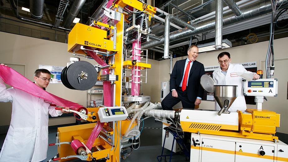 Dave Cote (left) in a New Jersey lab where Honeywell is developing a new nylon copolymer that can be used in food packaging. Around his office he typically wears jeans instead of a suit.