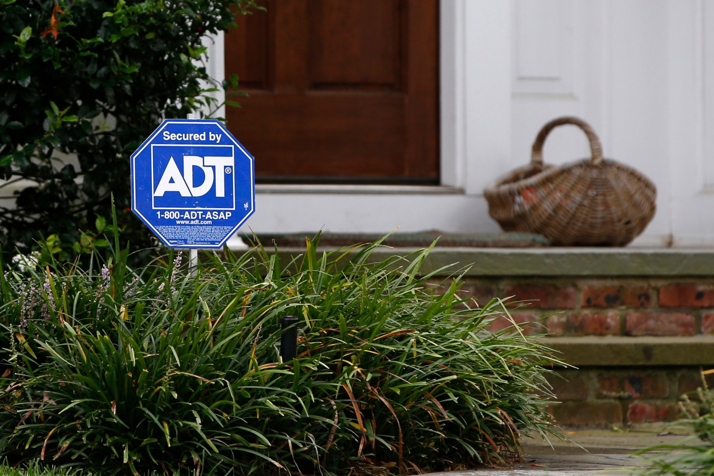 A security sign for ADT is seen outside a home in Port Washington, New York