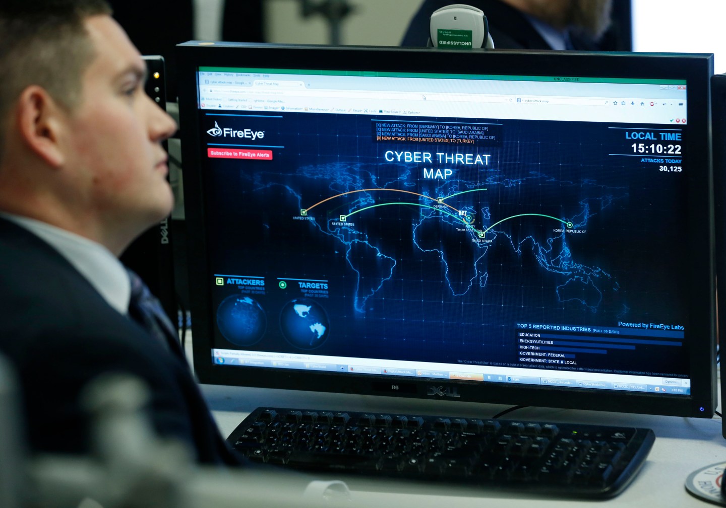 A Department of Homeland Security worker listen to U.S. President Barack Obama talk at the National Cybersecurity and Communications Integration Center in Arlington