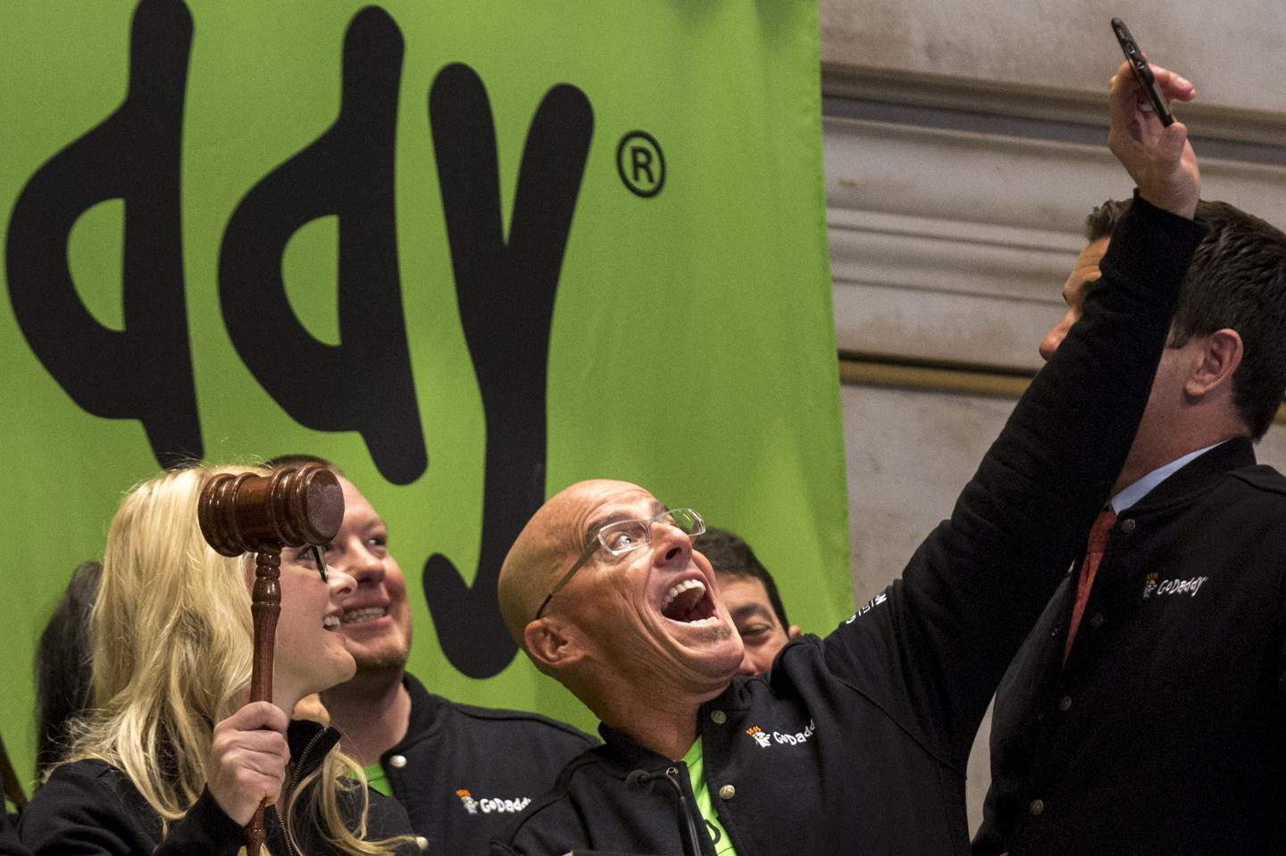 GoDaddy CEO Blake Irving takes "selfie" photo with a customer before they ring the opening bell to celebrate his web hosting company GoDaddy's IPO on the floor of the New York Stock Exchange